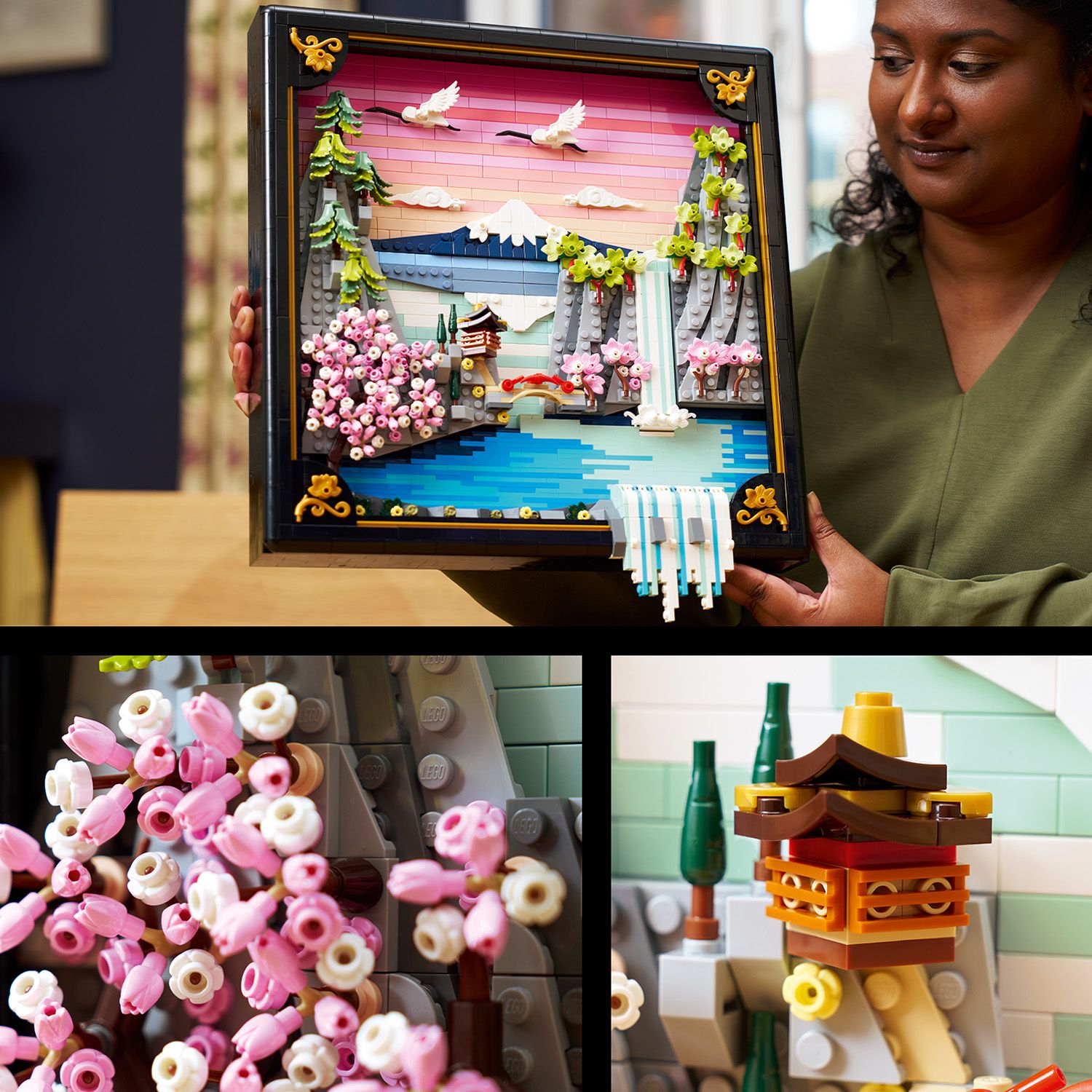 Gerahmtes LEGO Kunstwerk einer japanischen Kirschblütenlandschaft mit Bergen, Wasserfall, Kirschblütenbäumen und fliegenden Vögeln, gehalten von einer Person.