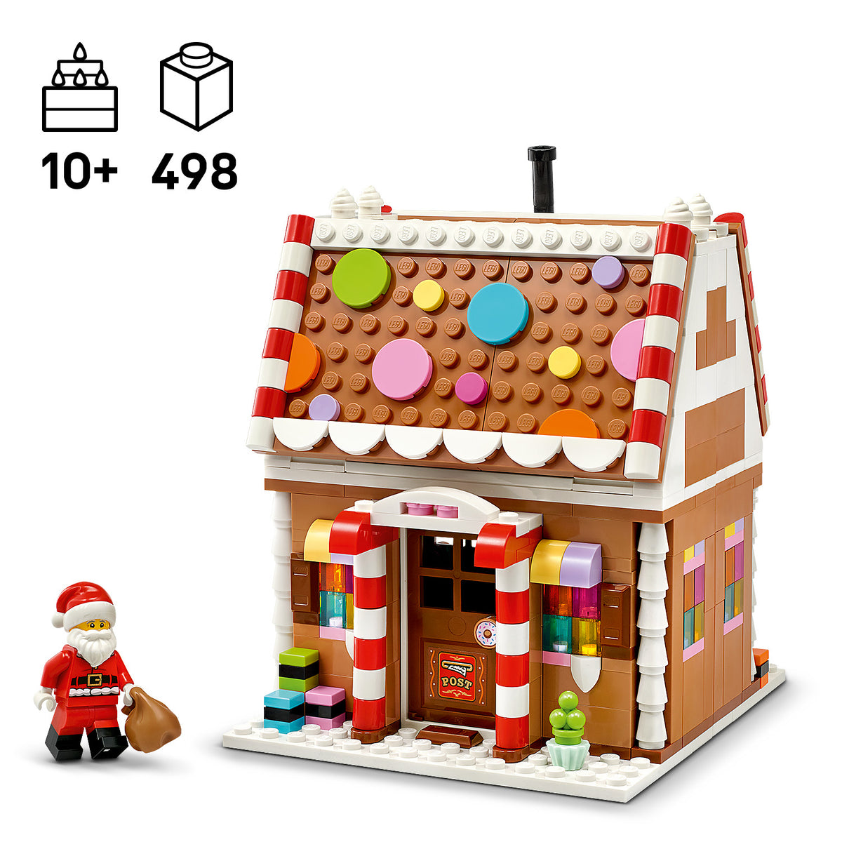 LEGO Modell eines Lebkuchenhauses mit bunten runden Dekorationen auf dem Dach, rot-weiß gestreiften Säulen am Eingang und einer kleinen Weihnachtsmannfigur mit Sack daneben