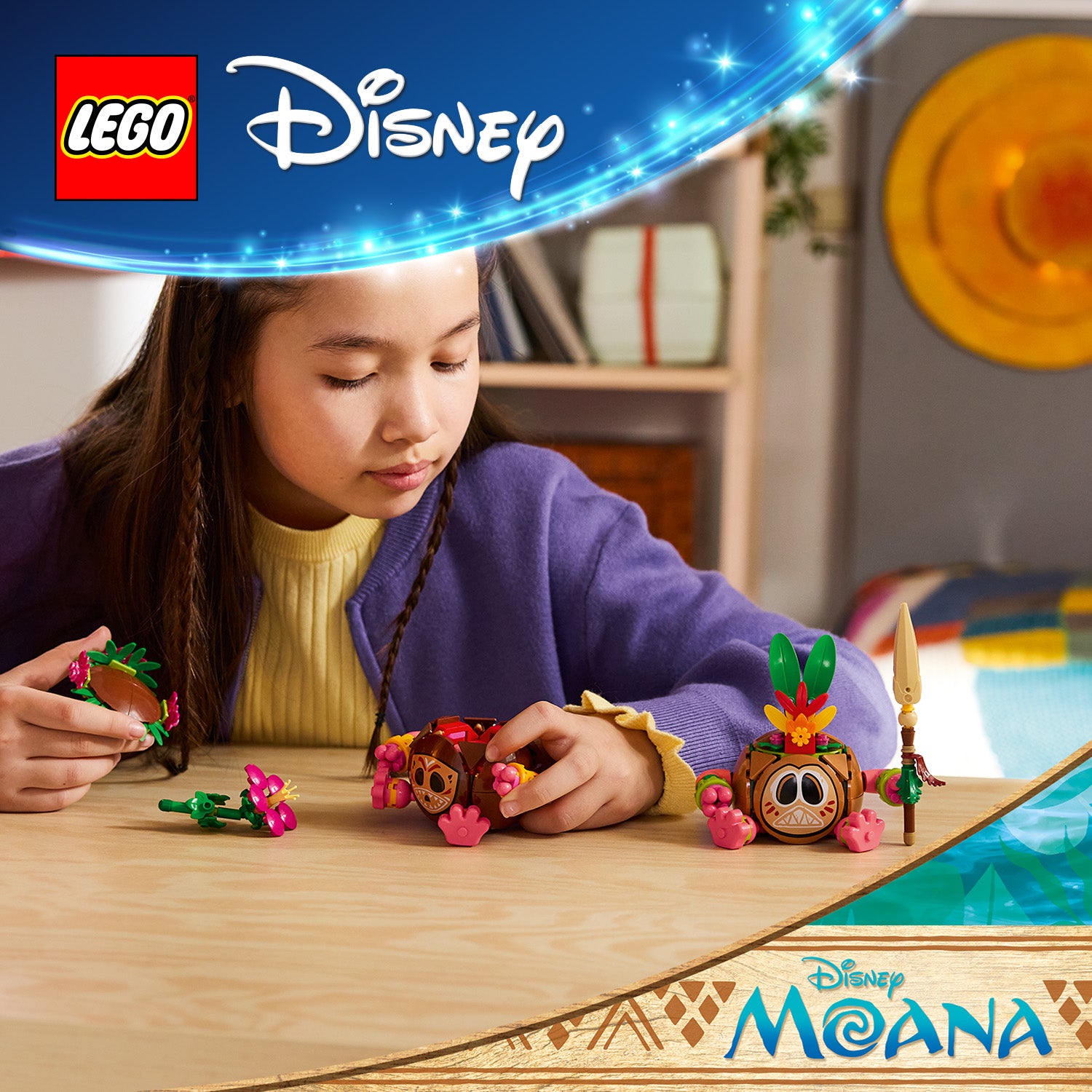 Kind spielt mit LEGO Disney-Moana Kakamora Figuren auf einem Holztisch in einem Zimmer mit Bücherregal und Wanddekoration