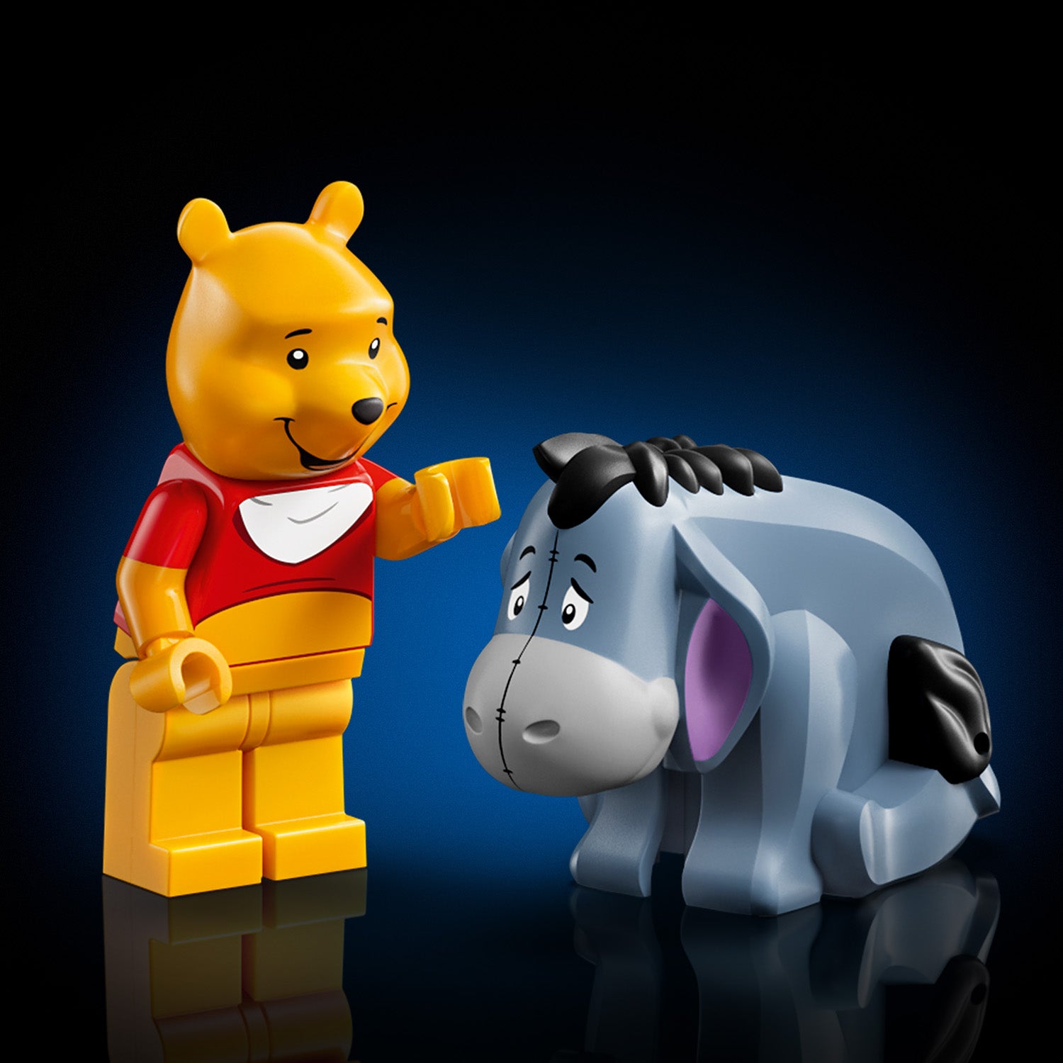 LEGO Figuren von Winnie Puuh mit rotem Hemd und Esel I-Aah mit traurigem Gesichtsausdruck vor blauem Hintergrund